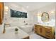 Modern bathroom featuring dual sinks, a soaking tub, and elegant fixtures at 3306 Sleepy Se Ln, Smyrna, GA 30080