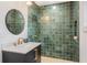 Stylish bathroom with a green tiled shower, sleek vanity, and gold fixtures at 3306 Sleepy Se Ln, Smyrna, GA 30080