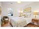 Cozy bedroom featuring a large window providing scenic views of the outdoors at 3306 Sleepy Se Ln, Smyrna, GA 30080