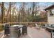 Spacious outdoor deck with comfortable seating and dining area, surrounded by mature trees at 3306 Sleepy Se Ln, Smyrna, GA 30080