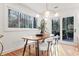 Dining area with large windows, hardwood floors, and modern light fixture at 3306 Sleepy Se Ln, Smyrna, GA 30080