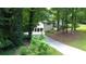 Traditional two-story home nestled in nature featuring a long driveway and two-car garage at 3306 Sleepy Se Ln, Smyrna, GA 30080
