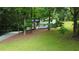 Charming two-story home with a well-manicured lawn and driveway tucked among mature trees at 3306 Sleepy Se Ln, Smyrna, GA 30080