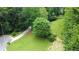 Well-manicured front yard featuring a long, curved driveway and mature trees at 3306 Sleepy Se Ln, Smyrna, GA 30080