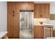 Kitchen featuring stainless steel refrigerator, custom wood cabinetry, and wine storage at 3306 Sleepy Se Ln, Smyrna, GA 30080