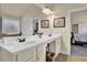 Bathroom featuring double sinks, a large mirror, and ample storage, offering functionality and style at 4315 Balsam Bark Dr, Cumming, GA 30028