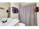 Compact bathroom showcases a vanity with sink and a shower with a striped curtain at 4315 Balsam Bark Dr, Cumming, GA 30028