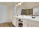 Bathroom featuring double sinks, a large mirror, and ample storage, offering functionality and style at 4315 Balsam Bark Dr, Cumming, GA 30028