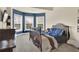 Bedroom with a bay window, carpet floors, and a bed dressed in blue bedding at 4315 Balsam Bark Dr, Cumming, GA 30028