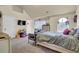 Cozy bedroom features vaulted ceiling, large arched window, and television with playful decor at 4315 Balsam Bark Dr, Cumming, GA 30028
