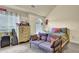 Inviting bedroom offers a sofa, a decorative dresser, and soft natural light from the window at 4315 Balsam Bark Dr, Cumming, GA 30028