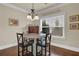 Breakfast nook features hardwood floors and a three pendant light fixture over the table at 4315 Balsam Bark Dr, Cumming, GA 30028