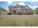 Charming two-story home with a manicured front lawn and a combination brick and stone facade at 4315 Balsam Bark Dr, Cumming, GA 30028
