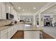 Bright kitchen featuring granite countertops, stainless steel appliances, a center island, and white cabinetry at 4315 Balsam Bark Dr, Cumming, GA 30028
