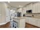 Kitchen featuring white cabinets, stainless appliances, an island with seating, and hardwood flooring at 4315 Balsam Bark Dr, Cumming, GA 30028