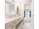 Elegant bathroom featuring a marble countertop, mosaic flooring, and a door leading to the bedroom at 1820 Peachtree Nw St # 608, Atlanta, GA 30309