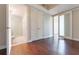 Hardwood-floored bedroom with an ensuite bathroom featuring a glass shower and mosaic tile flooring at 1820 Peachtree Nw St # 608, Atlanta, GA 30309