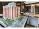 Architectural model showcasing the building's design, scale, and surrounding landscape with trees and cars at 1820 Peachtree Nw St # 608, Atlanta, GA 30309