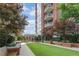 Exterior building with a beautiful courtyard featuring a lawn, seating, and landscaping at 1820 Peachtree Nw St # 608, Atlanta, GA 30309