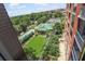 Condo view of community pool with lounge, mature trees, and residential buildings at 1820 Peachtree Nw St # 608, Atlanta, GA 30309