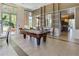 Community game room with pool table, seating area, and large windows at 1820 Peachtree Nw St # 608, Atlanta, GA 30309