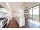Modern kitchen with stainless steel appliances, island, hardwood floors and large window at 1820 Peachtree Nw St # 608, Atlanta, GA 30309