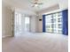 Bright living room with balcony access and floor-to-ceiling windows boasting city views and blue curtains at 1820 Peachtree Nw St # 608, Atlanta, GA 30309