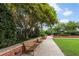 Outdoor seating area with benches, landscaping, and a shaded gazebo in a tranquil setting with a brick wall at 1820 Peachtree Nw St # 608, Atlanta, GA 30309