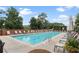 Relaxing community pool area with lounge chairs, lush greenery, and a pergola at 1820 Peachtree Nw St # 608, Atlanta, GA 30309