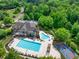 Community clubhouse with pools, basketball court, and parking surrounded by lush greenery at 2335 Flat Stone Dr, Cumming, GA 30041