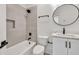 Bathroom with bathtub, black hardware, tile accent wall, and modern vanity mirror at 2335 Flat Stone Dr, Cumming, GA 30041