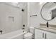 Modern bathroom features a tub, neutral tones, and a sleek round mirror at 2335 Flat Stone Dr, Cumming, GA 30041