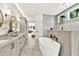 Luxurious bathroom with soaking tub, double vanity, and modern fixtures at 2335 Flat Stone Dr, Cumming, GA 30041