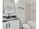 Bathroom with black countertop, white cabinets, and updated fixtures at 2335 Flat Stone Dr, Cumming, GA 30041
