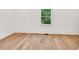 Bright bedroom features hardwood floors and a window with a view of the outside greenery at 2335 Flat Stone Dr, Cumming, GA 30041
