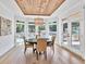 Charming breakfast nook boasts a beautiful backyard pool view, wood ceiling, and modern light fixture at 2335 Flat Stone Dr, Cumming, GA 30041