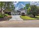 Elegant home featuring a spacious driveway, three-car garage, and beautiful landscaping at 2335 Flat Stone Dr, Cumming, GA 30041