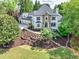 Beautiful home with stone accents, manicured lawn, and mature trees providing ample shade at 2335 Flat Stone Dr, Cumming, GA 30041