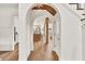 Bright hallway featuring an arched doorway, leading into the open concept living and kitchen space at 2335 Flat Stone Dr, Cumming, GA 30041