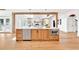 Kitchen island featuring stainless steel appliances and quartz counter with views of fireplace and backyard at 2335 Flat Stone Dr, Cumming, GA 30041