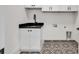 Laundry room features modern cabinet sink with black hardware and decorative tile flooring at 2335 Flat Stone Dr, Cumming, GA 30041