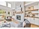 Inviting living room with stone fireplace, custom built-ins, and large windows at 2335 Flat Stone Dr, Cumming, GA 30041