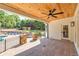 Covered patio with brick flooring, ceiling fan, stone pillars and view of backyard at 2335 Flat Stone Dr, Cumming, GA 30041