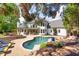Backyard features a large in-ground pool surrounded by lush landscaping and patio seating at 2335 Flat Stone Dr, Cumming, GA 30041