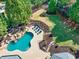 Aerial view of backyard with in-ground pool, waterfall feature, and lounging chairs at 2335 Flat Stone Dr, Cumming, GA 30041