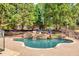 Relaxing backyard pool with waterfall feature, surrounded by lush greenery at 2335 Flat Stone Dr, Cumming, GA 30041
