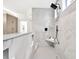 Modern shower features marble tile, a bench, and a rain shower head with sleek black hardware at 2335 Flat Stone Dr, Cumming, GA 30041