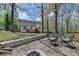 Backyard with an outdoor seating area, fire pit and deck, perfect for entertaining and enjoying the natural surroundings at 7040 Shady Oak Ln, Cumming, GA 30040