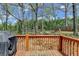 Large, wooded backyard with a deck and a cleared area for outdoor seating or recreation, offering privacy at 7040 Shady Oak Ln, Cumming, GA 30040