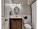 Charming bathroom with wainscoting, decorative mirror and updated fixtures at 7040 Shady Oak Ln, Cumming, GA 30040